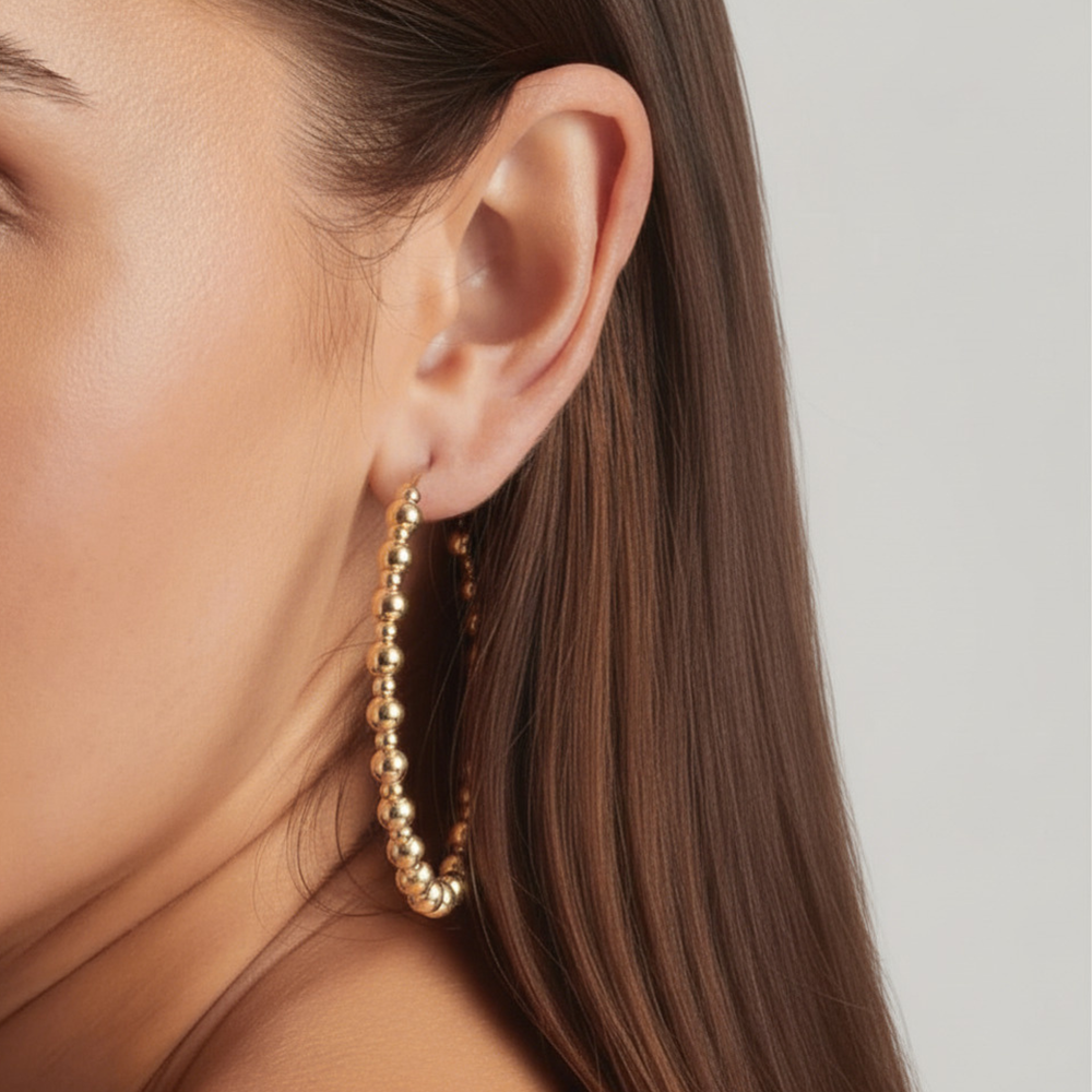 Close-up of a woman wearing 14K Gold Filled Aurelie hoop earrings 