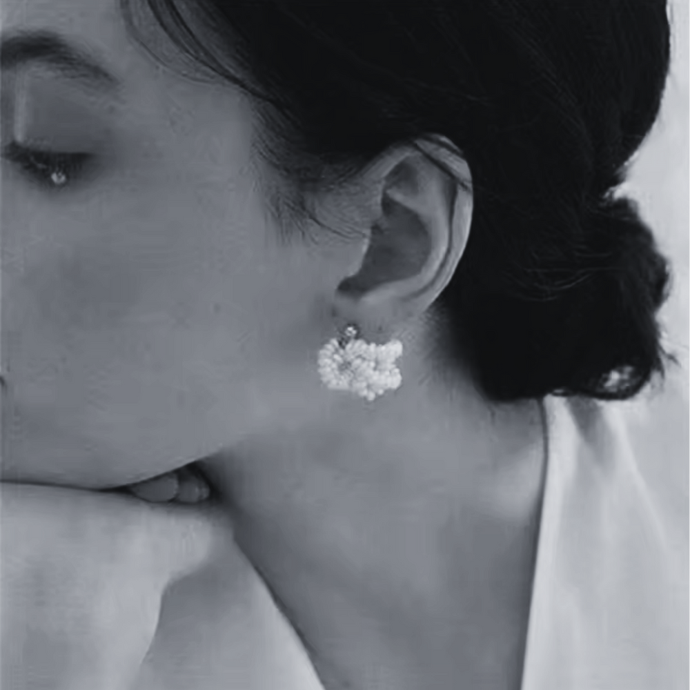 Close-up of a woman wearing 14K Gold Filled Fleur de Perle earrings 
