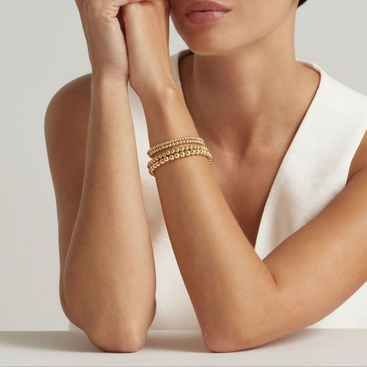 Woman wearing 14K Gold Filled Gilda bracelets in four sizes - demi-fine jewellery by Margot Georgia