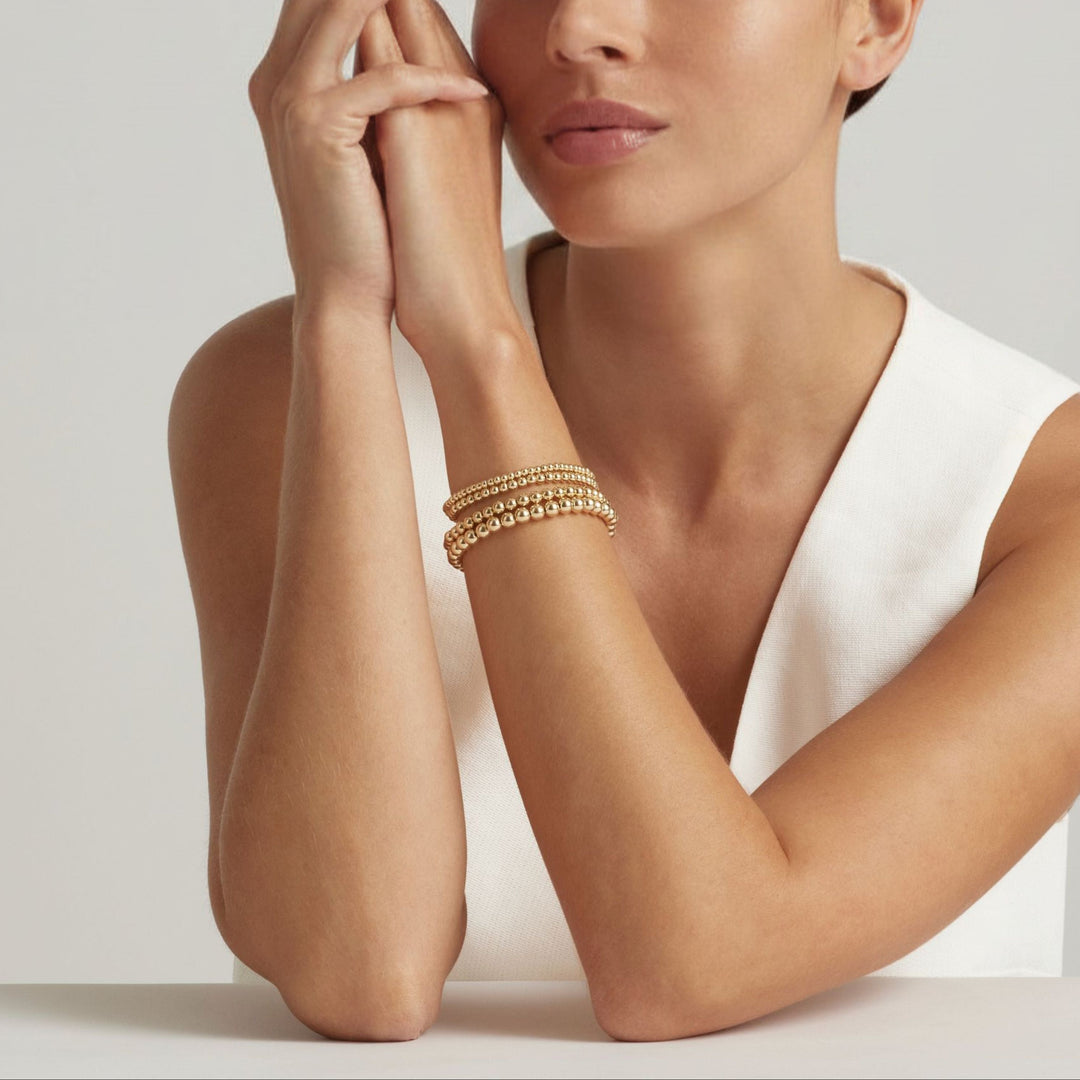 Woman wearing 14K Gold Filled Gilda bracelets in four sizes - demi-fine jewellery by Margot Georgia