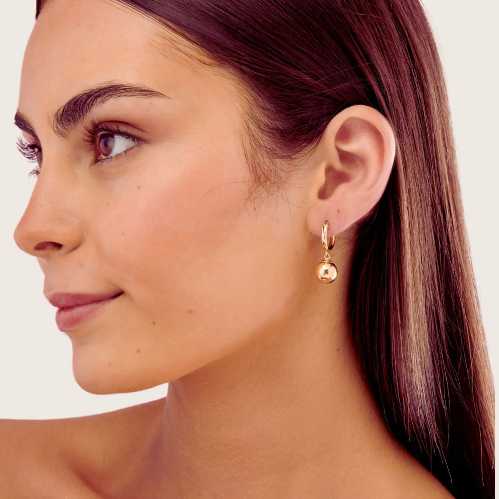 Close-up of a woman wearing 14K Gold Filled Golden Orb earrings - demi-fine jewllery by Margot Georgia