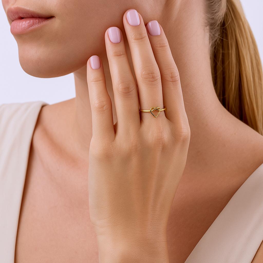 14K Gold Filled Heart Knot stacking ring worn on model's hand