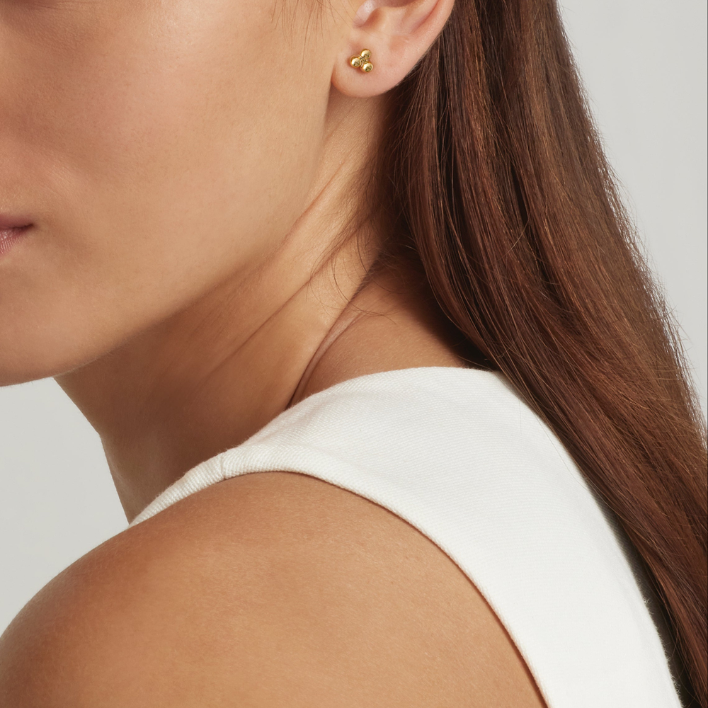 Close-up of a woman wearing 14K Gold Filled Trinity stud earrings - demi-fine jewellery by Margot Georgia