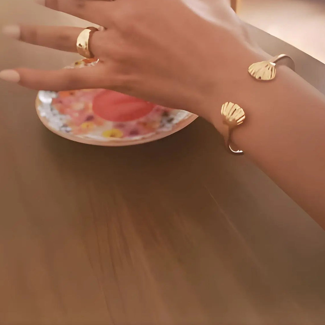 Close-up of hand and wrist showcasing 14K Gold Vermeil Dome Elysse ring and Oyster of Nerida cuff bangle - demi-fine jewellery by Margot Georgia