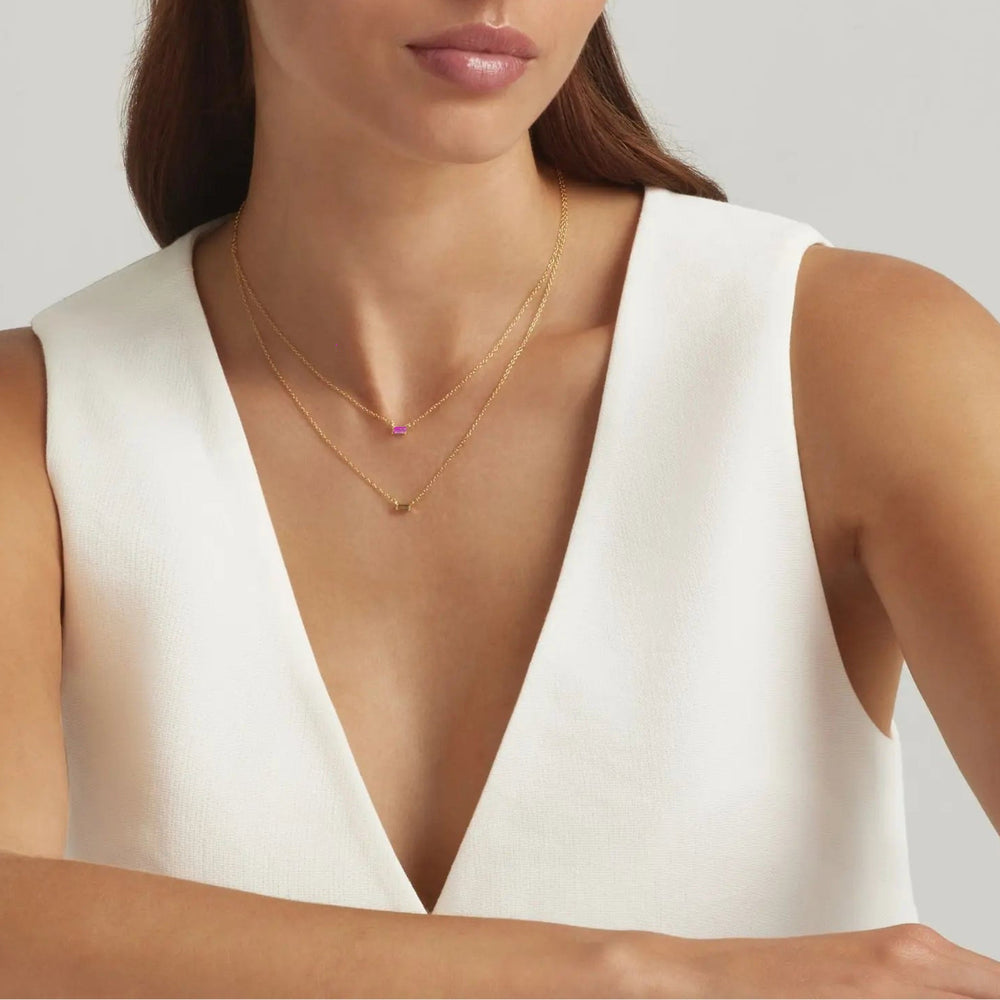 Woman wearing 18K Gold Plated Baguette Birthstone Bar necklace - pink tourmaline and peridt green - demi-fine jewellery by Margot Georgia