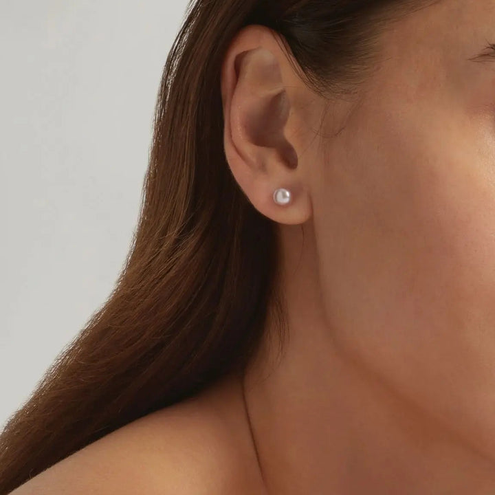 Close-up of 18K Gold Plated Boraluxe pearl stud earrings on model - demi-fine jewellery by Margot Georgia