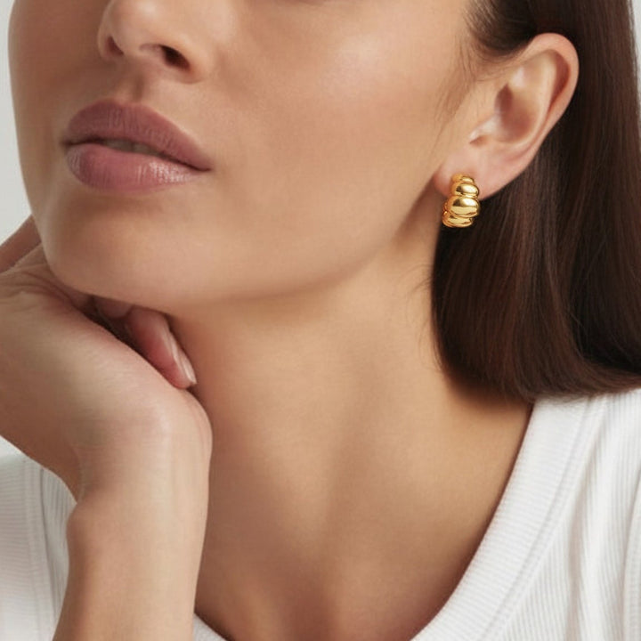 Close-up of a woman wearing 18K Gold Plated Croissant Dome drop earrings - demi-fine jewellery by Margot Georgia