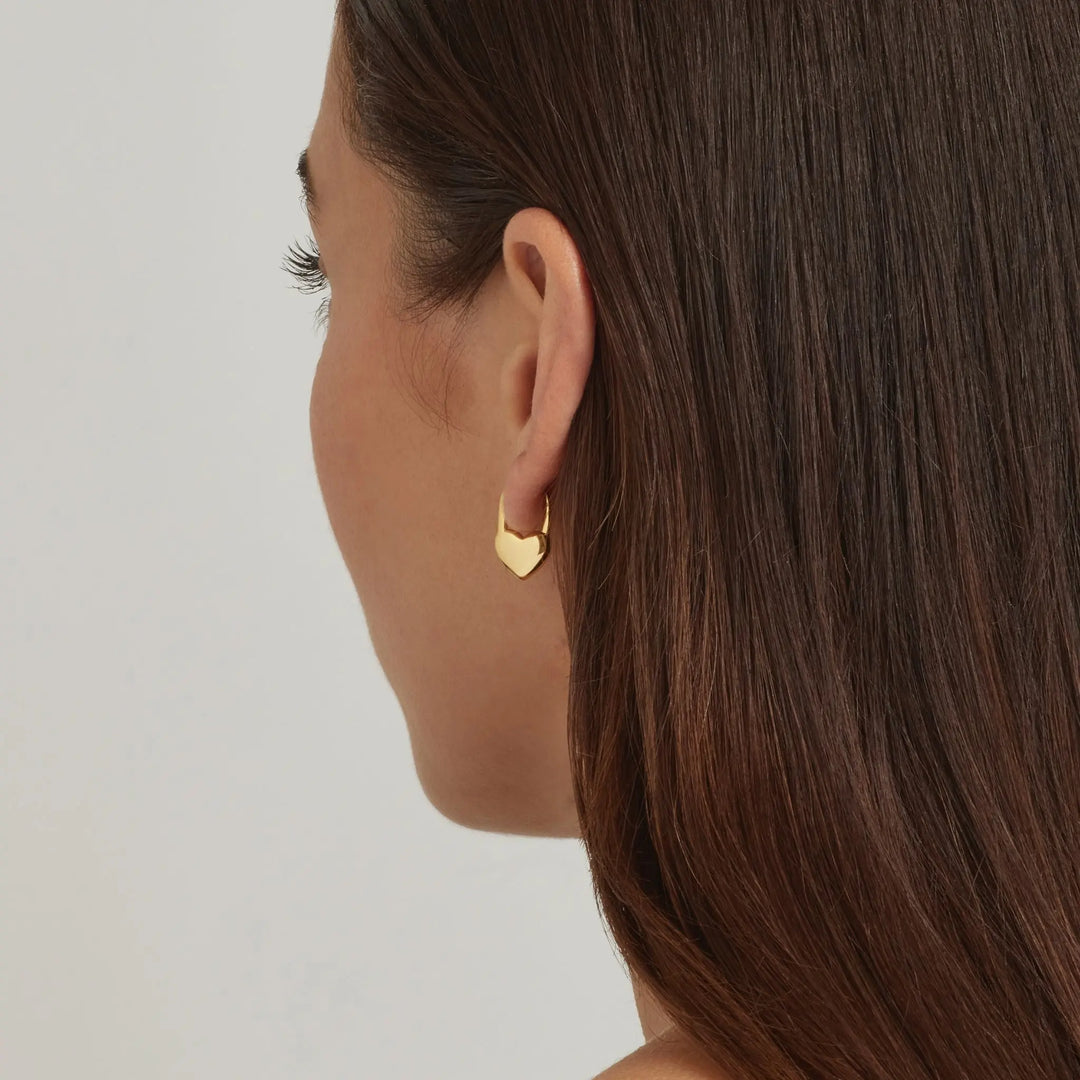 Close-up of a model wearing 18K Gold Plated Heart hoop earrings - demi-fine jewellery by Margot Georgia