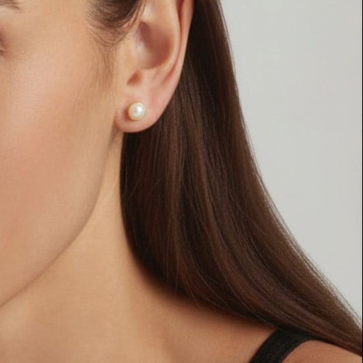 Woman wearing 18K Gold Plated Lulu Pearl stud earrings - demi-fine jewellery by Margot Georgia