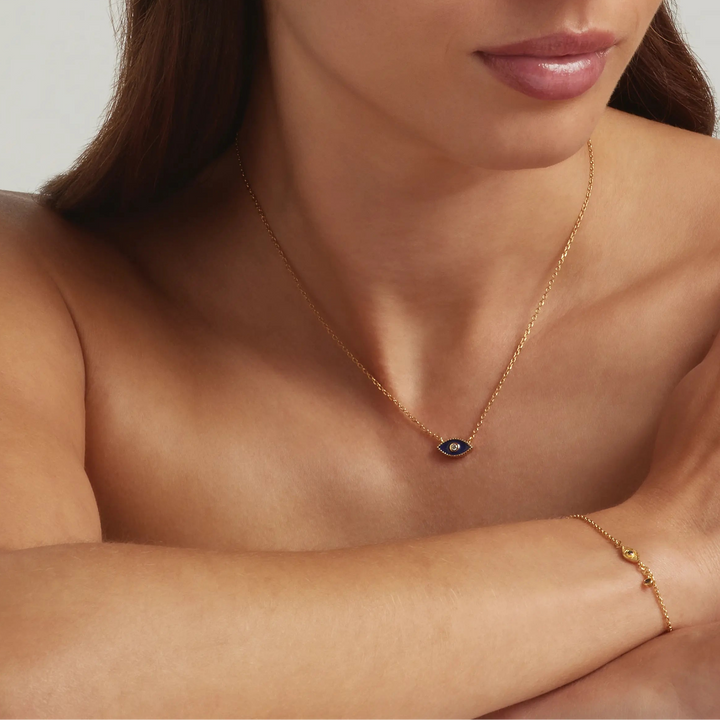 Woman wearing 18K Gold Vermeil Jacalin Evil Eye necklace and bracelet set - demi-fine jewellery by Margot Georgia