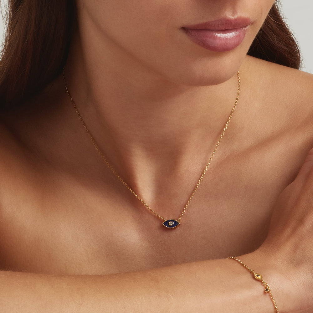 Close-up of a woman wearing 18K Gold Vermeil Jacalin Evil Eye necklace and bracelet - demi-fine jewellery by Margot Georgia