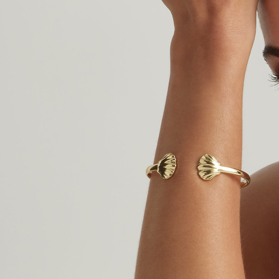 Woman wearing 18K Gold Vermeil Oyster of Nerida cuff bangle - demi-fine jewellery by Margot Georgia