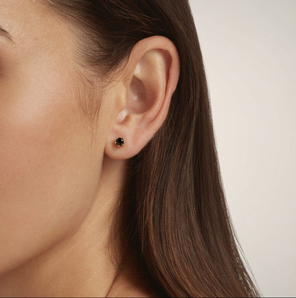 Close-up of a model wearing 18K Gold Vermeil Round Sapphire Blue stud earrings - demi-fine jewellery by Margot Georgia