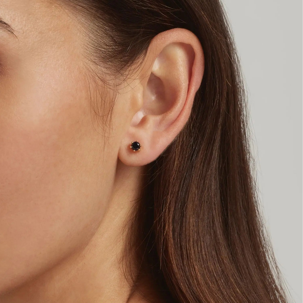 Close-up of a model wearing 18K Gold Vermeil Round Sapphire Blue stud earrings - demi-fine jewellery by Margot Georgia