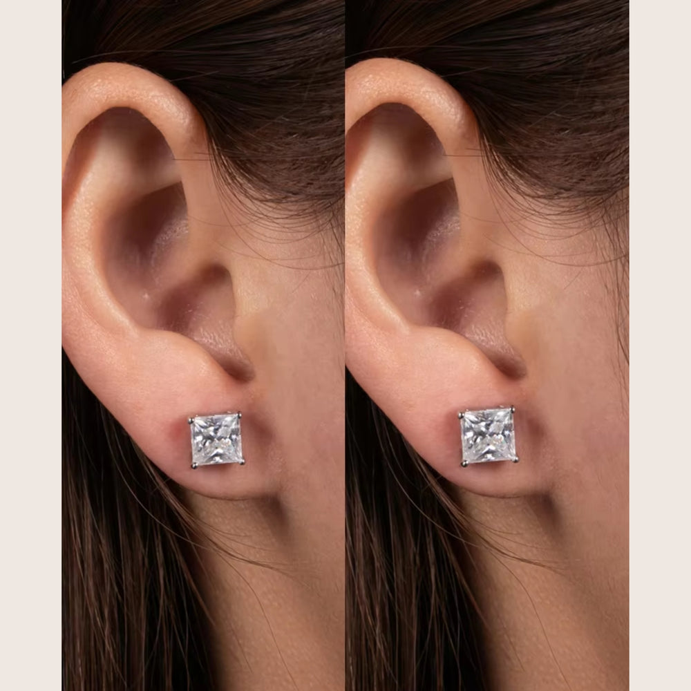 A size comparison on a model's ear of 2 CTTW and 4 CTTW 18K White Gold Diamante Moissanite stud earrings in white