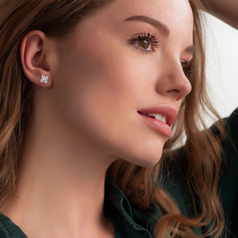 Woman wearing 18K White Gold Four Leaf Clover moissanite earrings - demi-fine jewellery by Margot Georgia