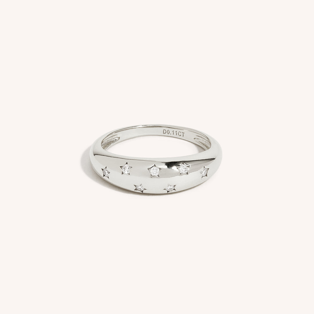 An 18K gold ring with multiple sparkling moissanite stones set in the band, displayed against a white background.