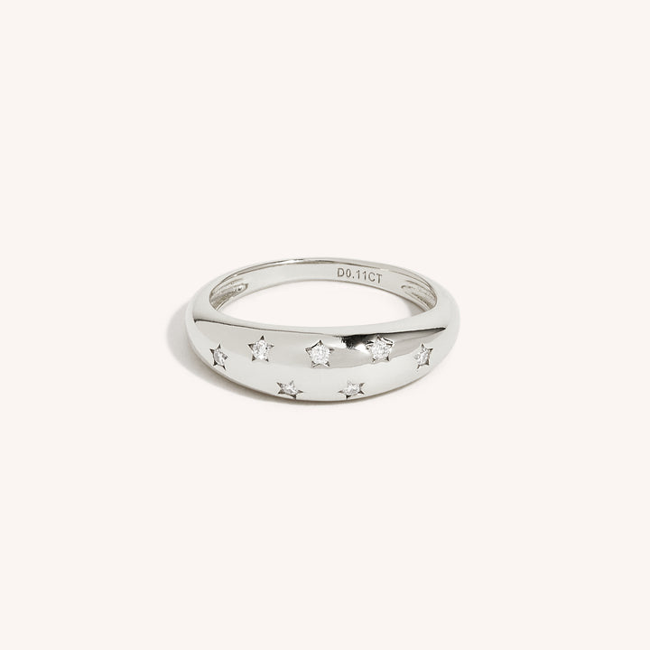 An 18K gold ring with multiple sparkling moissanite stones set in the band, displayed against a white background.