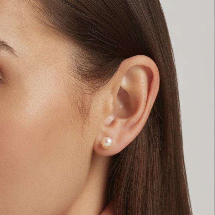 Close-up of an ear showcasing 925 Sterling Silver Lula pearl stud earrings in light pink - demi-fine jewellery by Margot Georgia
