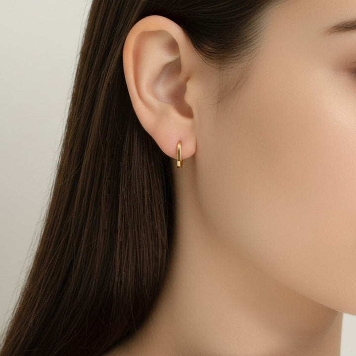 Close-up of 9K Solid Gold Maisee Huggies  earrings on model